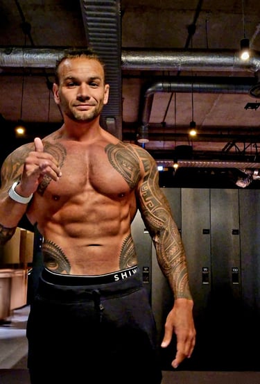 a man with tattoos on his chest and chest