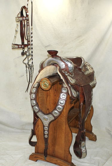 Antique brown and silver saddle that comes with matching bridle and martingale. 