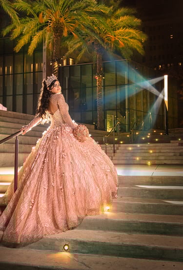 a woman in a pink quinceanera dress and umbrella