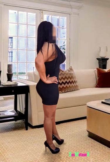 a woman in a short dress standing in a living room