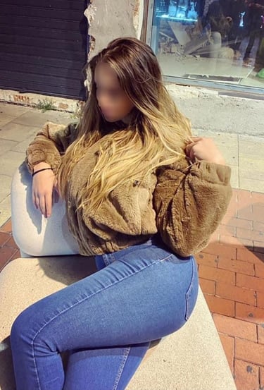 a woman escort sitting on a bench in a city