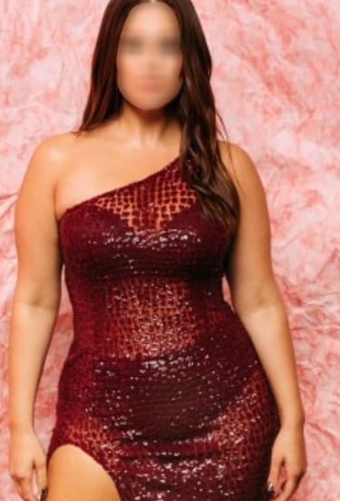 a woman in a red dress with a thigh high slit