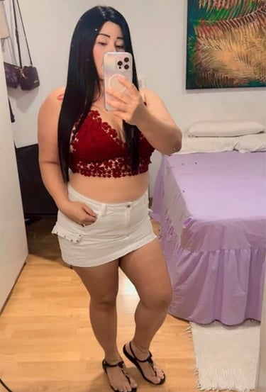 Viky con falda blanca y top rojo, look casual sexy frente al espejo