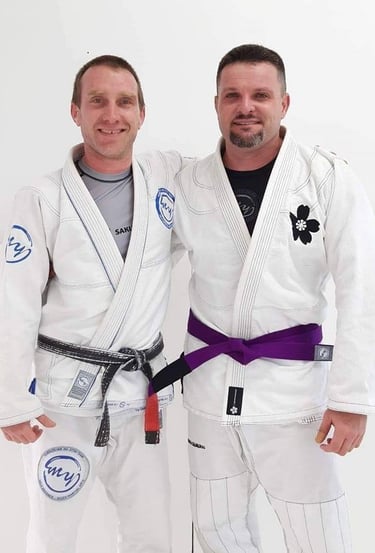 two men standing next to each other in a white room