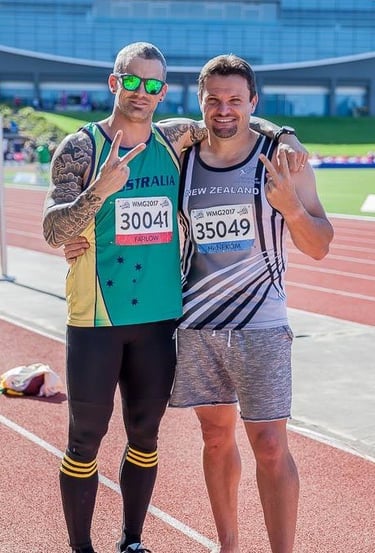 two male athletes posing for a photo
