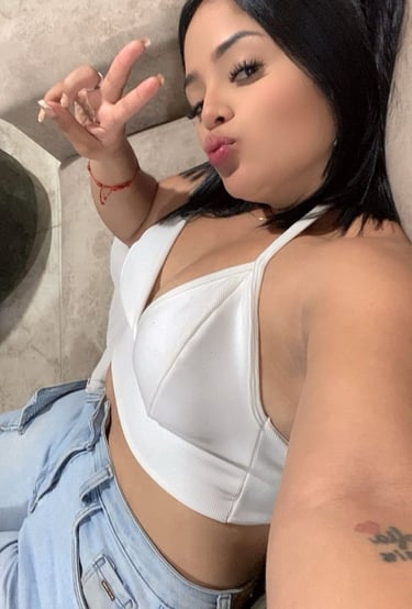 a woman with a white bra top and jeans