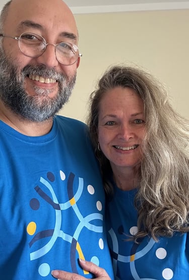a man and woman in matching blue shirts