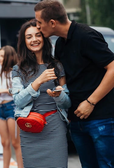 a husband and wife kissing in the street