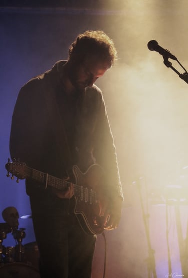 Dorian Chamoin playing guitar in a concert