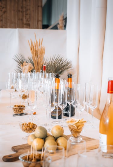a table with wine glasses and wine bottles