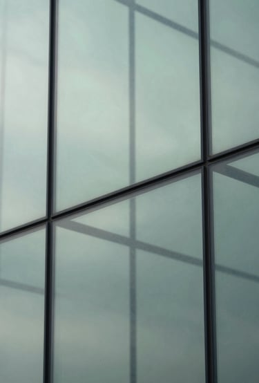Abstract representation of mental clarity, structured geometric glass elements reflecting soft overcast daylight, cool clean tones with subtle sage green highlights, minimalist composition, 35mm lens