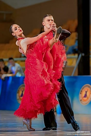 a ballroom couple staying at pose where a women  holding her leg up 