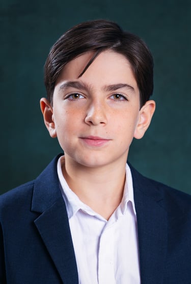a young boy with a white shirt and a blue jacket