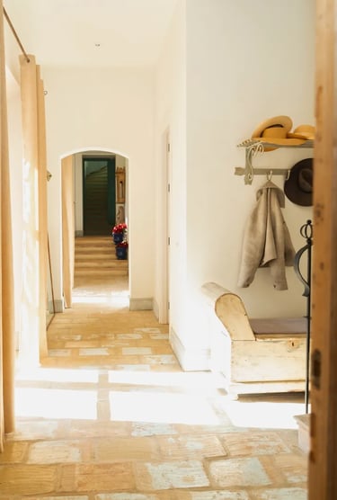 Stone hallway with arched doorway at Finca Santa Katerina