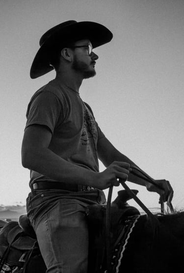 a man in a cowboy hat riding a horse