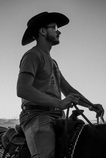 a man in a cowboy hat riding a horse