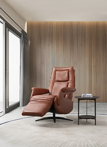 a reclining chair with a reclining chair in a room