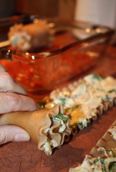 rolling lasagna noodles with chicken cheese mixture