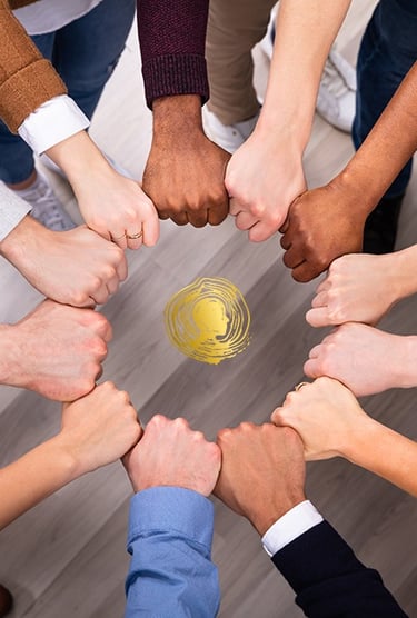 a group of people holding hands together in a circle
