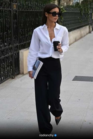 a woman in a white shirt and black pants