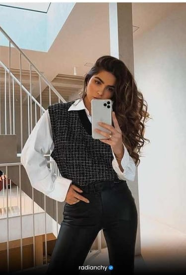 a woman in a black vest and white shirt