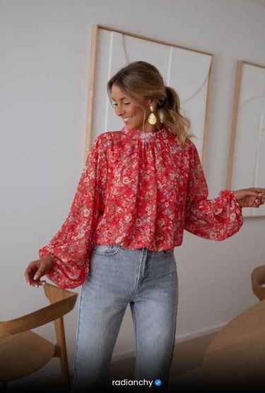 a woman in a red blouse and jeans jeans