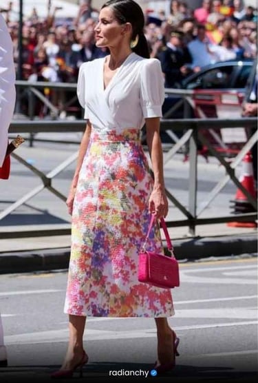 a woman in a white blouse and pink skirt