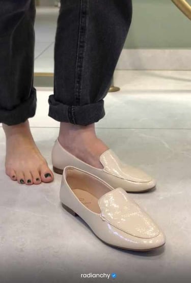 a person standing on a steplade with their feet on the ground
