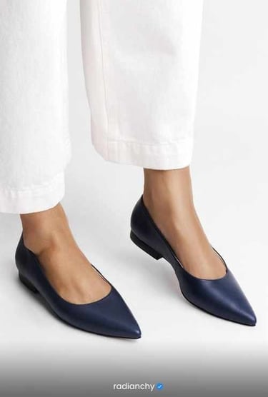 a woman's feet in white pants and white pants