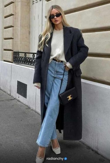 a woman in a white sweater and jeans jeans and a coat