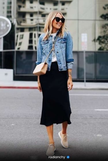 a woman in a black skirt and denim jacket
