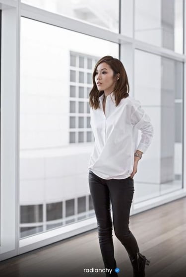 a woman in a white shirt and black pants