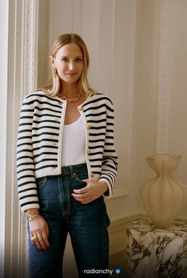 a woman in a striped cardigan sweater and jeans