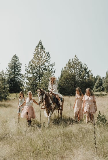 bridesmaid photos, bride riding paint horse, field, pine trees, Big Arm State Park