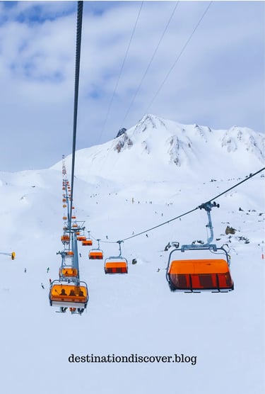 Yellow ski gondola moving above snow-covered slopes in the Austrian Alps. Skiers visible below on th