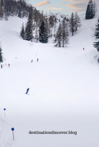 Skier carving down a wide, sunny ski slope in an Austrian ski resort. High, snow-capped mountain pea