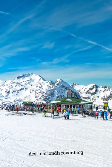 Group of people enjoying a sunny day at the summit of an Austrian ski resort. Scenic view of mountai
