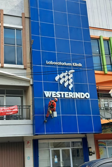 a man on a motorcycle is hanging from a building