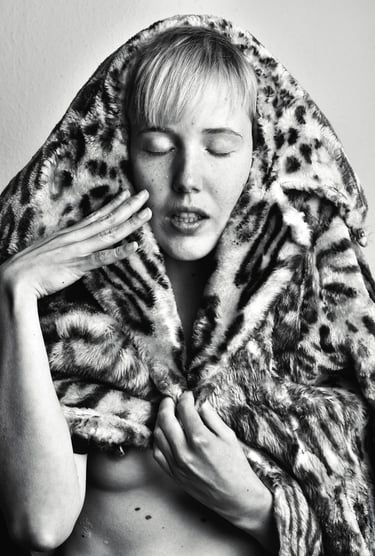 a woman in a leopard print coat and a leopard print coat posing for a photo