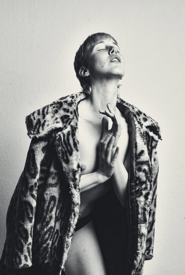 a woman in a leopard print coat and a leopard print coat posing for a photo