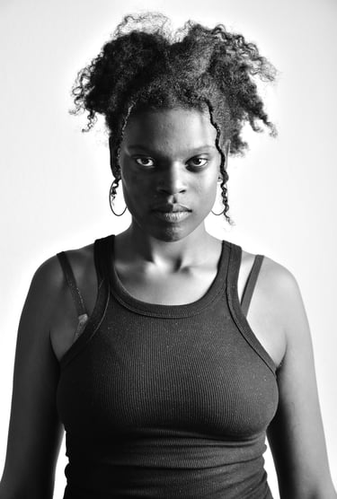 a woman with curly hair and a black tank top