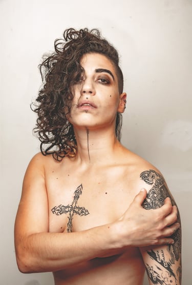 a woman with tattoos on her posing for a photo