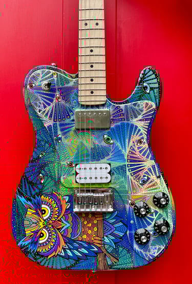 Owel Psychedelic Guitar. Hand-painted by Nancy Elhallak of Graffiti Garage. Donated to the London Roundhouse and signed 