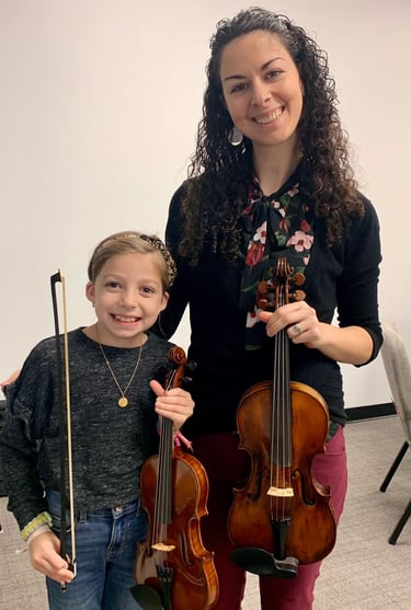 Child taking violin lesson