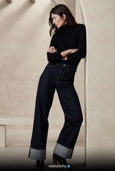 a woman in a black top and jeans jeans