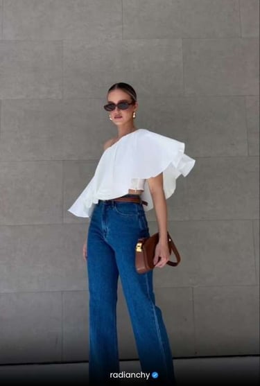 a woman in a white top and jeans jeans