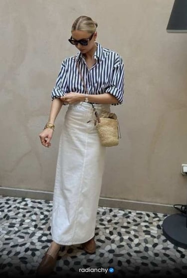 a woman in a striped shirt and skirt