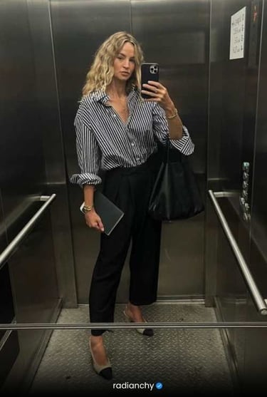 a woman in a striped shirt and black pants