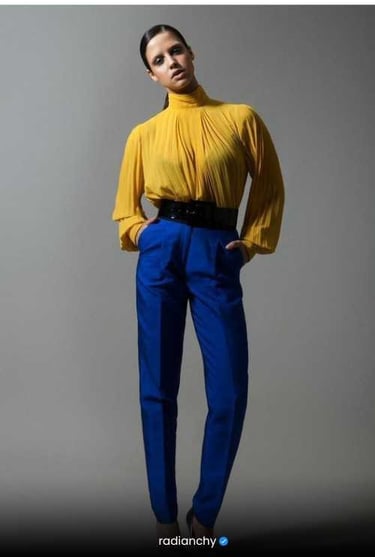 a woman in a yellow blouse and blue pants