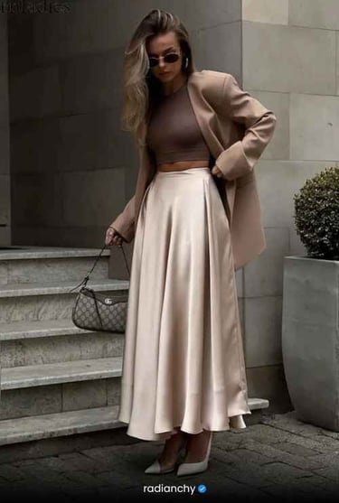 a woman in a tan coat and a tan skirt